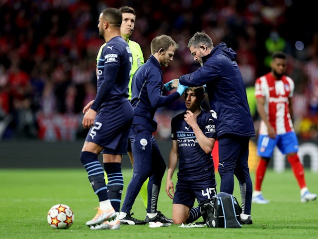 Manchester City's Phil Foden receives medical attention after sustaining an injury on April 13, 2022