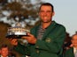 Scottie Scheffler of the U.S. celebrates with his green jacket and trophy after winning The Masters on April 10, 2022