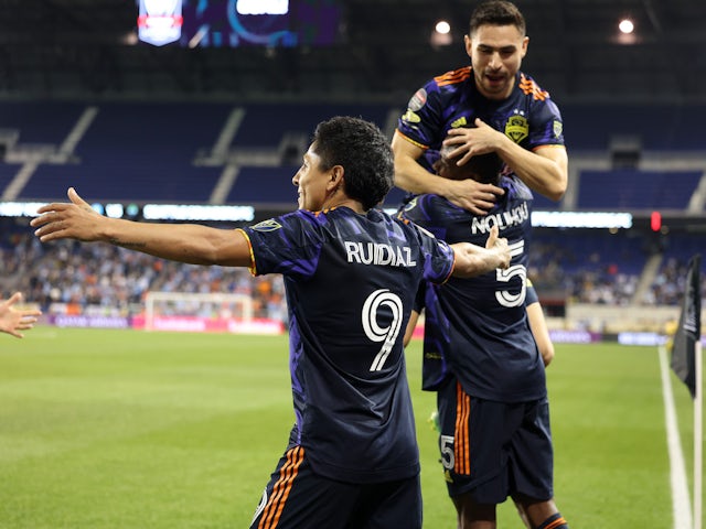 Seattle Sounders forward Raul Ruidiaz (9) celebrates with teammates after scoring a first-half goal against New York City FC on April 13, 2022 at Red Bull Arena
