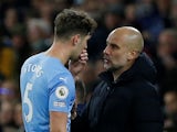 Manchester City manager Pep Guardiola speaks to John Stones on April 20, 2022