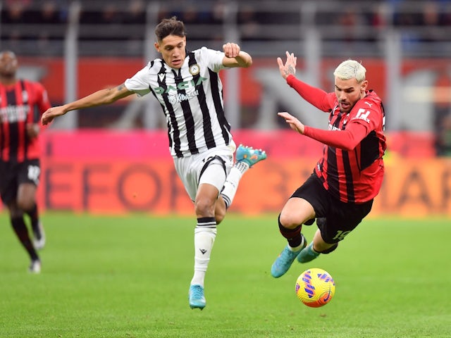 Udinese's Nahuel Molina in action with AC Milan's Theo Hernandez on February 25, 2022