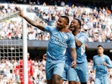 Manchester City's Gabriel Jesus celebrates with Raheem Sterling after scoring their fourth goal to complete his hat-trick on April 23, 2022