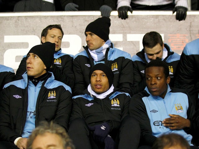 Manchester City's Costel Pantilimon, Nigel De Jong and Nedum Onuoha on the bench on January 16, 2012