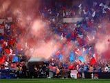 Crystal Palace fans wave flags before the match on April 17, 2022