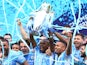 Manchester City's Fernandinho lifts the trophy as he celebrates with teammates after winning the Premier League on May 22, 2022
