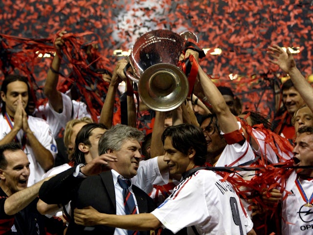 AC Milan manager Carlo Ancelotti embraces striker Filippo Inzaghi as the Champions League trophy is lifted on May 28, 2003