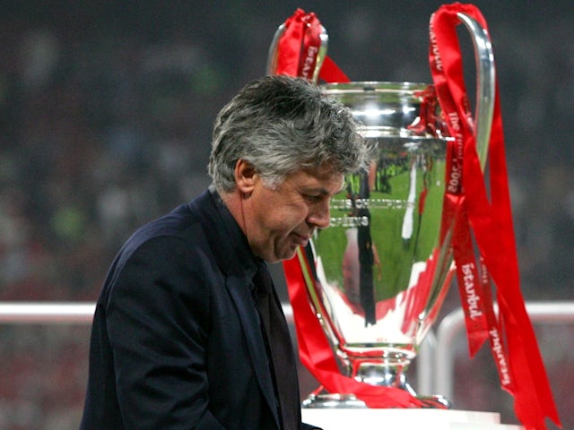 AC Milan's managerCarlo Ancelotti reacts as he passes the Champions League trophy after losing the final against Liverpool on May 25, 2005