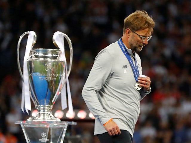 Liverpool manager Jurgen Klopp walks past the Champions League trophy with his medal after losing the final on May 26, 2018