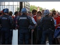 Suppoters and riot police pictured outside the Stade de France before the Champions League final on May 28, 2022