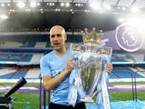 Manchester City manager Pep Guardiola celebrates with the trophy after winning the Premier League on May 22, 2022