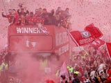 Liverpool players celebrate in an open-top bus parade on May 29, 2022