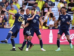 Sporting Kansas City midfielder Graham Zusi (8) celebrates with teammates after a goal during the second half against Nashville SC at Geodis Park on June 19, 2022