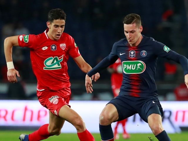 Dijon's Nayef Aguerd in action with Paris Saint-Germain's Julian Draxler on February 26, 2019