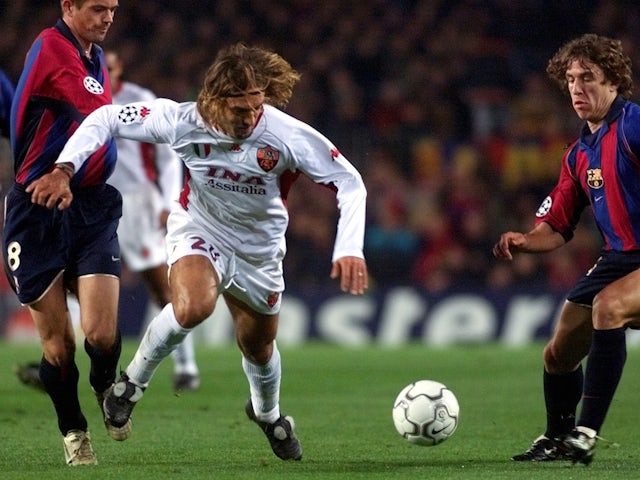 Roma's Gabriel Omar Batistuta battling for the ball with Barcelona's Philippe Cocu and Carlos Puyol on February 20, 2002.