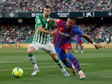 Real Betis' Guido Rodriguez in action with FC Barcelona's Memphis Depay on May 7, 2022
