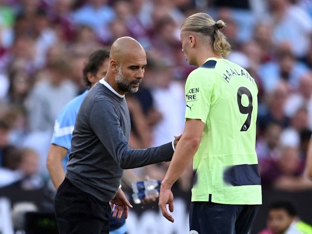 Manchester City's Erling Braut Haaland shakes hands with manager Pep Guardiola after being substituted off on August 7, 2022