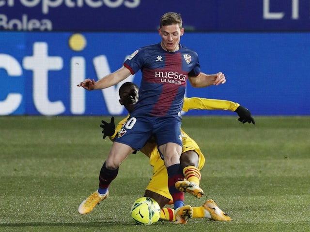 Huesca's Sergio Gomez in action with Barcelona's Ousmane Dembele on January 3, 2021