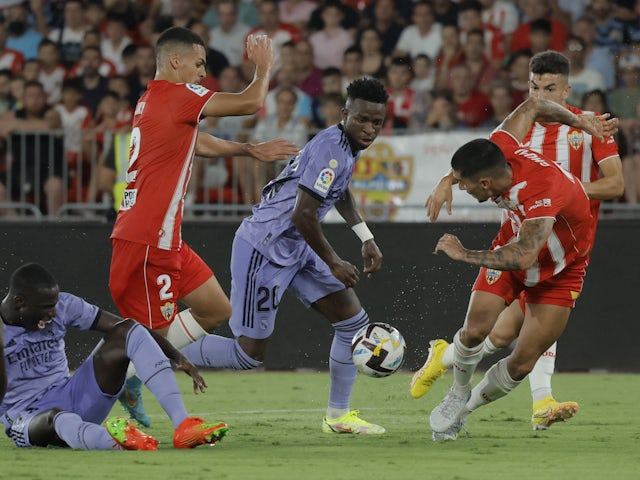 Real Madrid's Vinicius Junior in action with Almeria's Kaiky on August 14, 2022