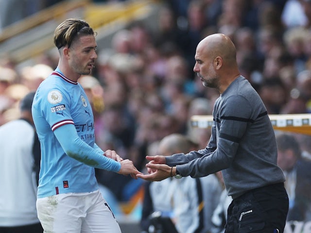 Manchester City's Jack Grealish with manager Pep Guardiola after being substituted on September 17, 2022