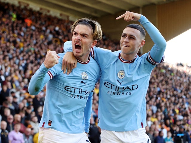 Manchester City's Jack Grealish celebrates scoring their first goal with Phil Foden on September 17, 2022