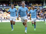 Manchester City's Jack Grealish celebrates scoring their first goal with Bernardo Silva and Rodri on September 17, 2022