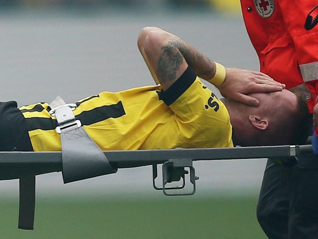 Borussia Dortmund's Marco Reus is taken off injured on September 17, 2022
