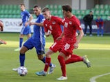 Moldova's Vadim Bolohan in action with Liechtenstein's Andrin Netzer and Niklas Beck on September 25, 2022