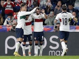 Portugal's Bruno Fernandes celebrates scoring their second goal with Mario Rui and Cristiano Ronaldo on September 24, 2022