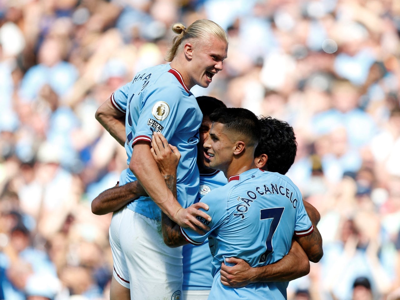Manchester City's Ilkay Gundogan celebrates scoring their first goal with Erling Braut Haaland, Rodri and Joao Cancelo on August 13, 2022