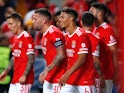 Benfica players celebrate an own goal by Paris Saint-Germain's Danilo Pereira on October 5, 2022