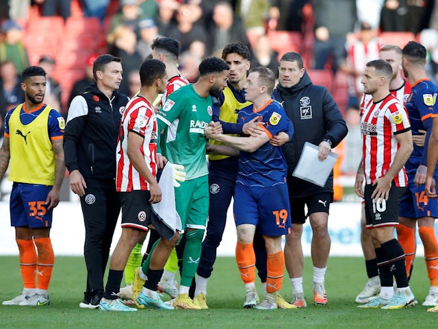 Sheffield United's Wes Foderingham and Blackpool's Shayne Lavery react after they receive red cards after the match on October 15, 2022