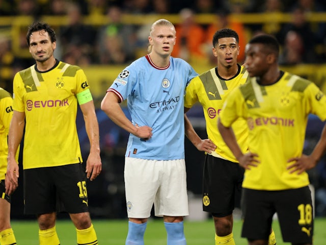 Manchester City's Erling Braut Haaland in action with Borussia Dortmund's Jude Bellingham and Mats Hummels on October 25, 2022