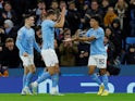 Manchester City's Rico Lewis celebrates scoring their first goal with Ruben Dias and Phil Foden on November 2, 2022