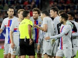 Barcelona's Robert Lewandowski with teammates remonstrate with referee Jesus Gil Manzano after being shown the red card on November 8, 2022