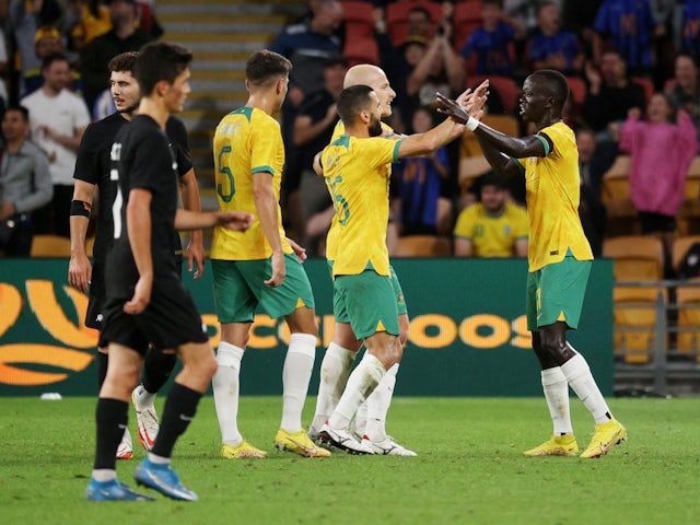 Australia's Awer Mabil celebrates scoring their first goal with teammates in September 2022