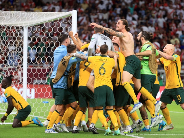 Australia players celebrate after qualifying to the FIFA World Cup in June 2022