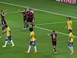 Andre Schurrle celebrates with team mates after scoring the sixth goal for Germany against Brazil at the 2014 World Cup