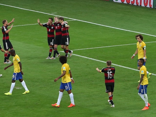 Andre Schurrle celebrates with team mates after scoring the sixth goal for Germany against Brazil at the 2014 World Cup