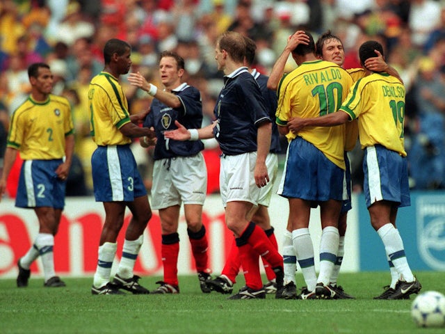 Brazil and Scotland players embrace each other at the end of the game at the 1998 World Cup
