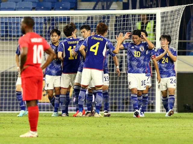 Japan celebrate scoring against Canada in a World Cup warm-up match on November 17, 2022.