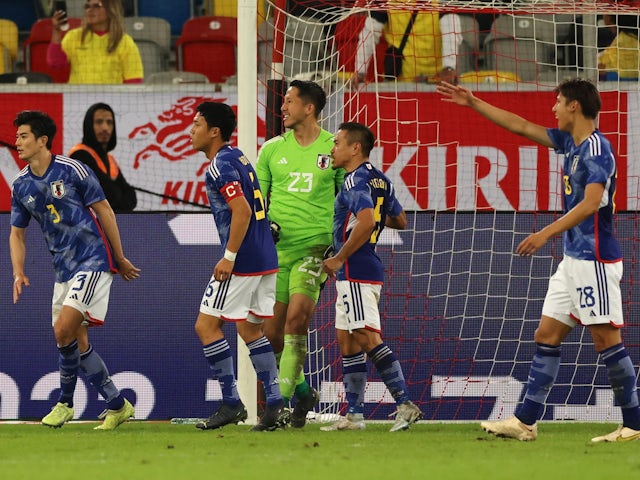 Japan's Daniel Schmidt celebrates with team mates after saving a penalty from Ecuador's Enner Valencia in September 2022