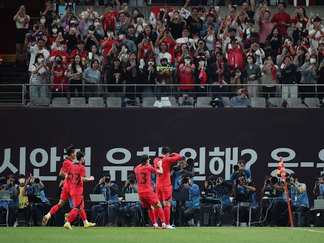 South Korea's Son Heung-min celebrates scoring their first goal with teammates and fans in September 2022