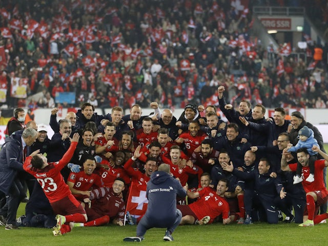 Switzerland players pose for a picture to celebrate winning the match and qualifying for the Qatar 2022 World Cup on November 15, 2021