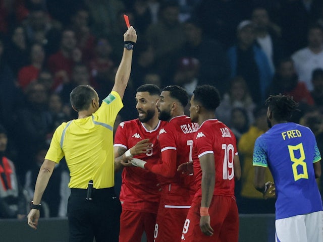 Tunisia's Dylan Bronn is shown a red card by referee Ruddy Buquet in September  2022