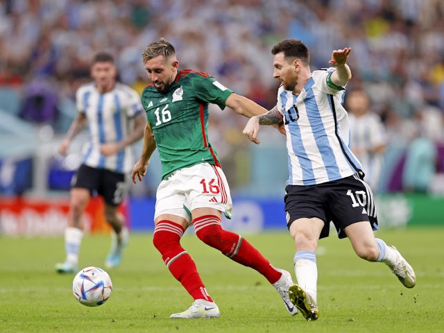 Argentina's Lionel Messi in action with Mexico's Hector Herrera at the World Cup on November 26, 2022