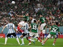 Argentina's Lautaro Martinez battles Mexico's Cesar Montes for the ball at the World Cup on November 26, 2022