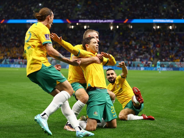 Australia's Craig Goodwin celebrates scoring their first goal with Riley McGree, Jackson Irvine and Aziz Behich on November 20, 2022