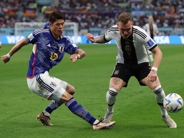 Japan's Hiroki Sakai in action with Germany's David Raum at the World Cup on November 23, 2022