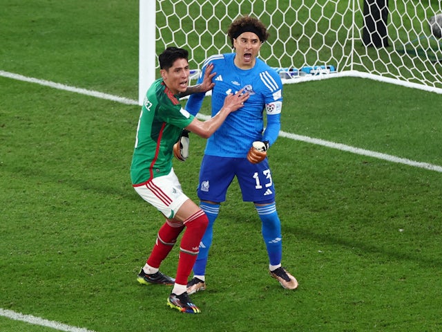 Mexico's Guillermo Ochoa celebrates after saving a penalty from Poland's Robert Lewandowski, pictured on November 22, 2022