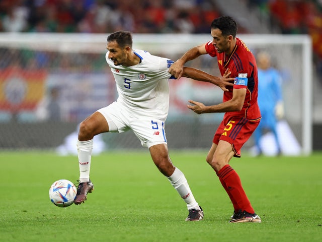 Costa Rica's Celso Borges in action with Spain's Sergio Busquets at the World Cup on November 23, 2022
